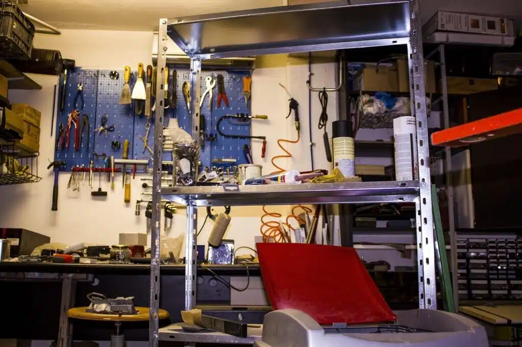 Workshop with a tool wall and a shelf full of tools and devices