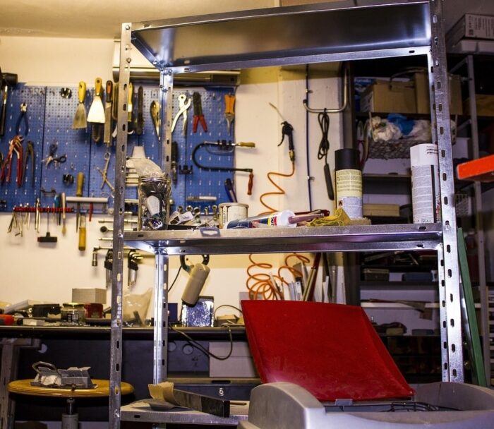 Workshop with a tool wall and a shelf full of tools and devices